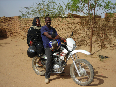 Taha and Khadija motorcycling to the villages, Hadjer Hadid, Chad