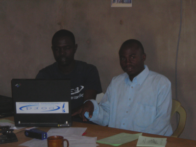 Yacoub helping Taha enter statistics from the villages, Hadjer Hadid, Chad
