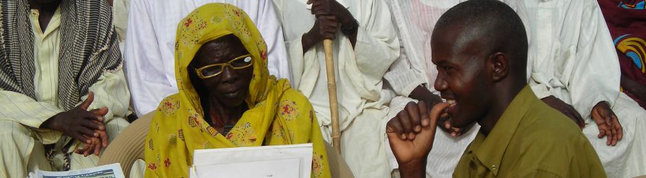 Darfuri woman tested for reading glasses in Bredjing Refugee Camp, Chad
